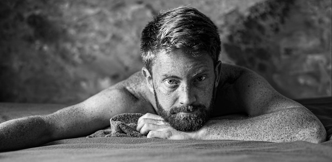 A person awake at night near a window, representing disrupted sleep from frequent urination
