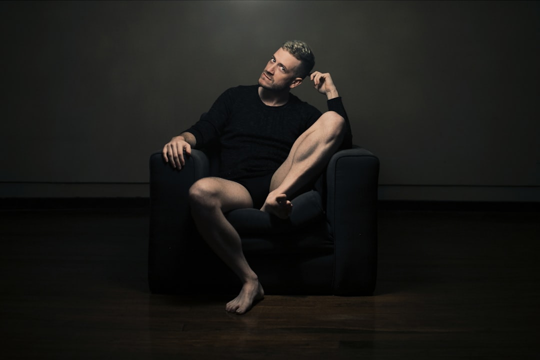 A person awake at night near a window, representing disrupted sleep from frequent urination